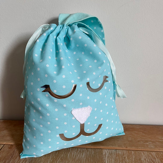 Light blue polka dot drawstring bag with a bunny face design