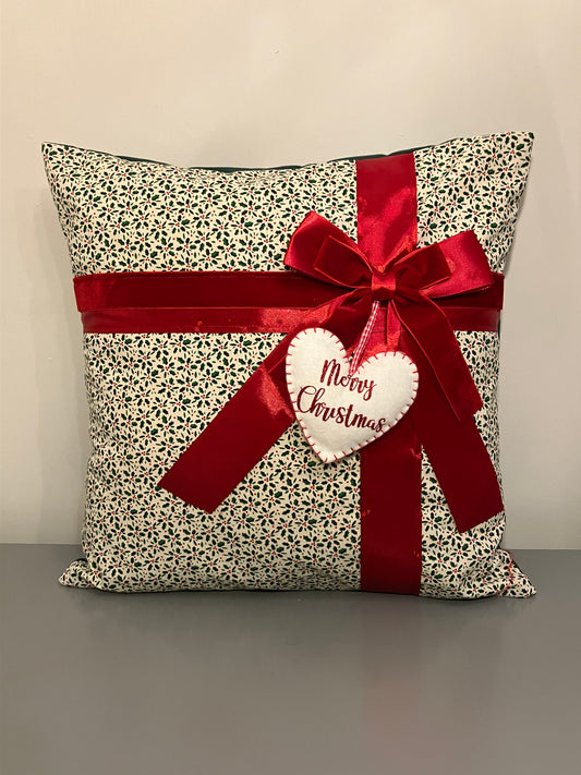 A decorative cushion with a red ribbon and a heart-shaped 'Merry Christmas' tag.
