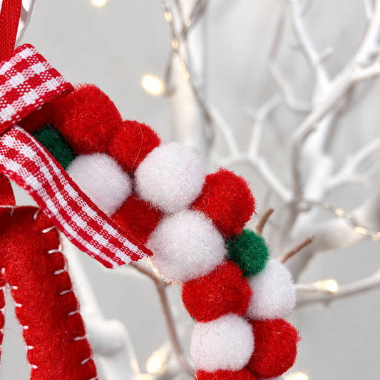 Red and white pom-pom garland with a red and white checkered bow.