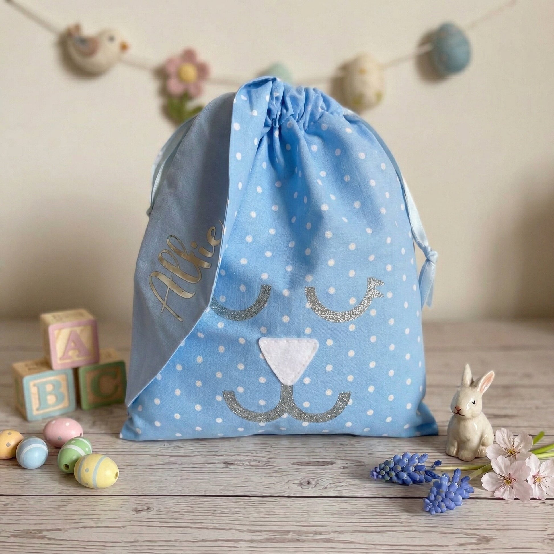 Blue polka dot drawstring bag with bunny face, personalized with the name Allie