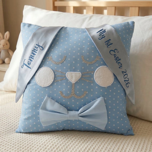 Blue polka dot bunny cushion with embroidered ears, one reading Tommy, the other My 1st Easter 2026.