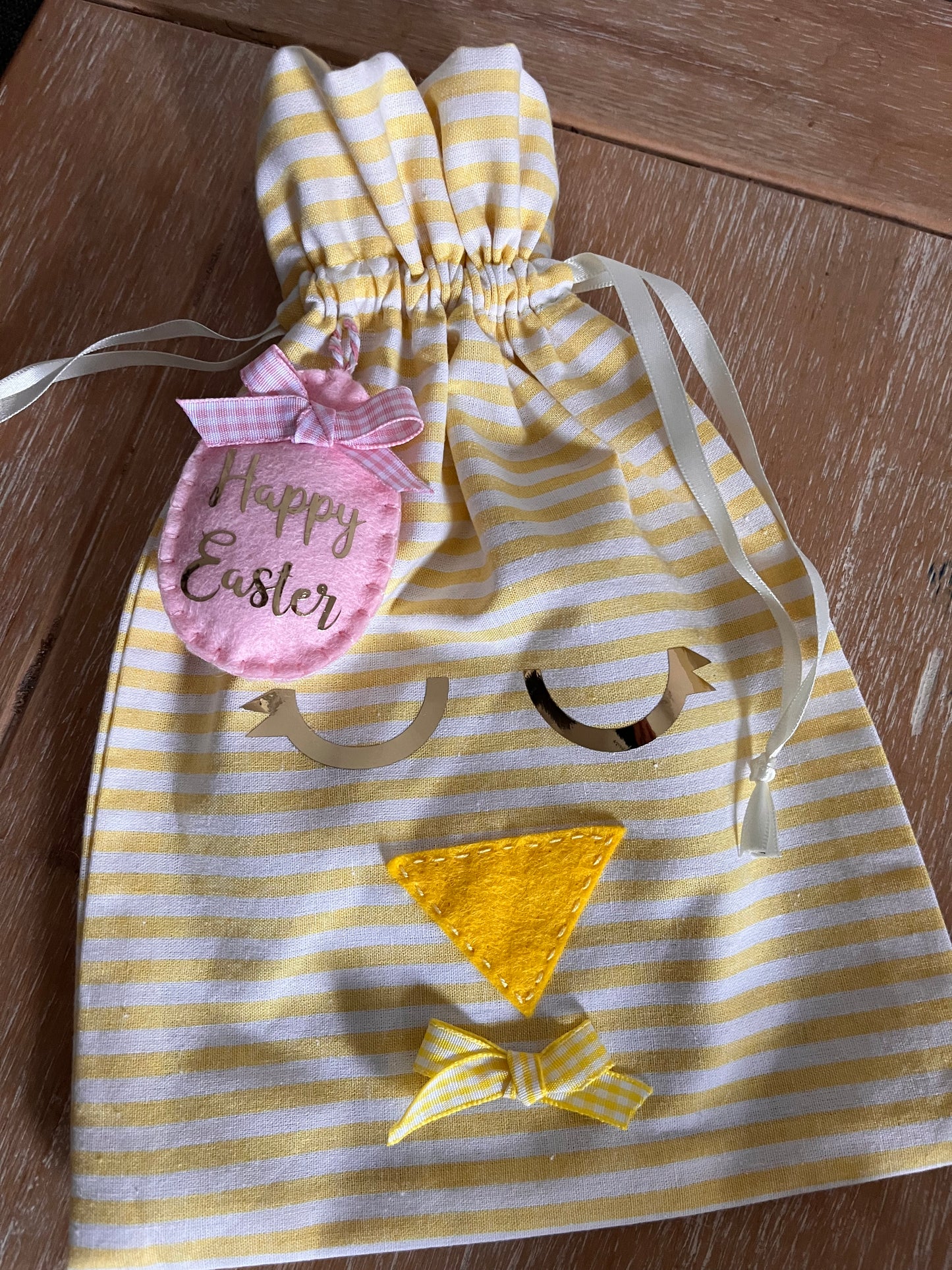 Yellow and white striped Easter chick gift bag with a pink Happy Easter tag.