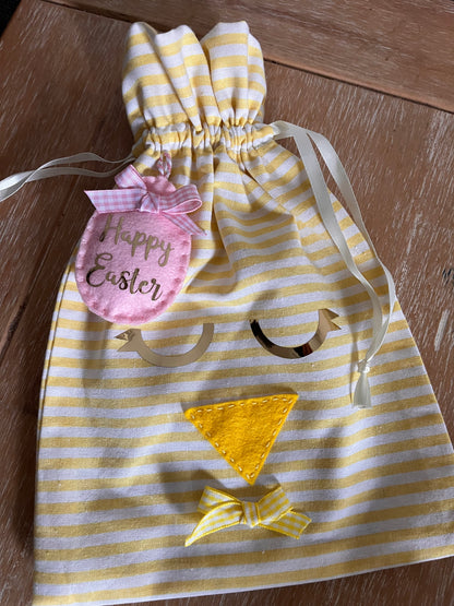 Yellow and white striped Easter chick gift bag with a pink Happy Easter tag.