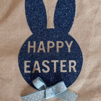 Happy Easter bunny design on burlap with a blue polka dot bow.