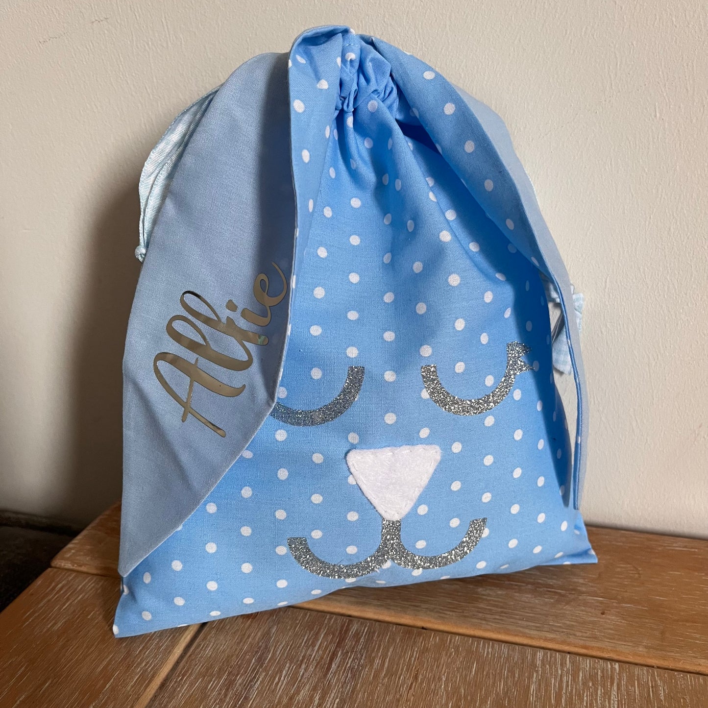 Light blue polka dot drawstring bag with bunny face and name Allie