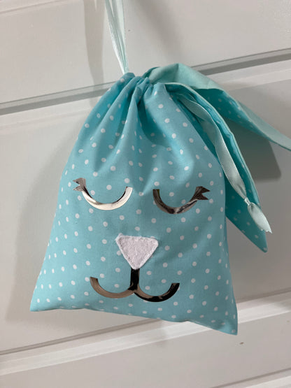 Blue polka dot drawstring bag with a bunny face design