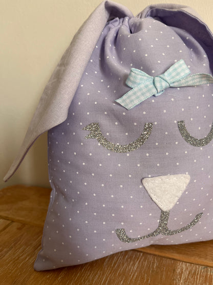 Purple polka dot bunny bag with glittery eyes, white nose, and blue gingham bow