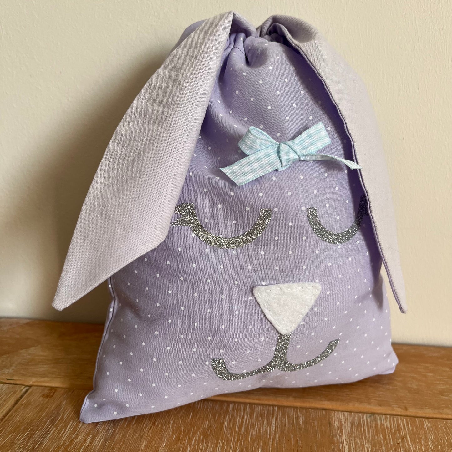 Purple polka dot bunny bag with glitter face and blue bow