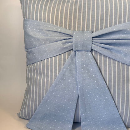 Blue and white striped cushion with a blue polka dot bow