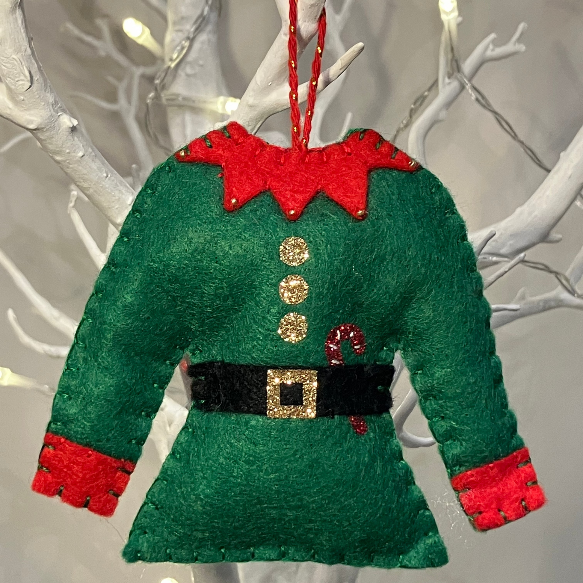 Green felt elf shirt with red collar and cuffs, black belt, gold buckle, and candy cane.
