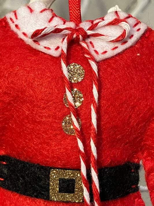 Close-up of the collar and buttons of a red Santa's jacket Christmas decoration.