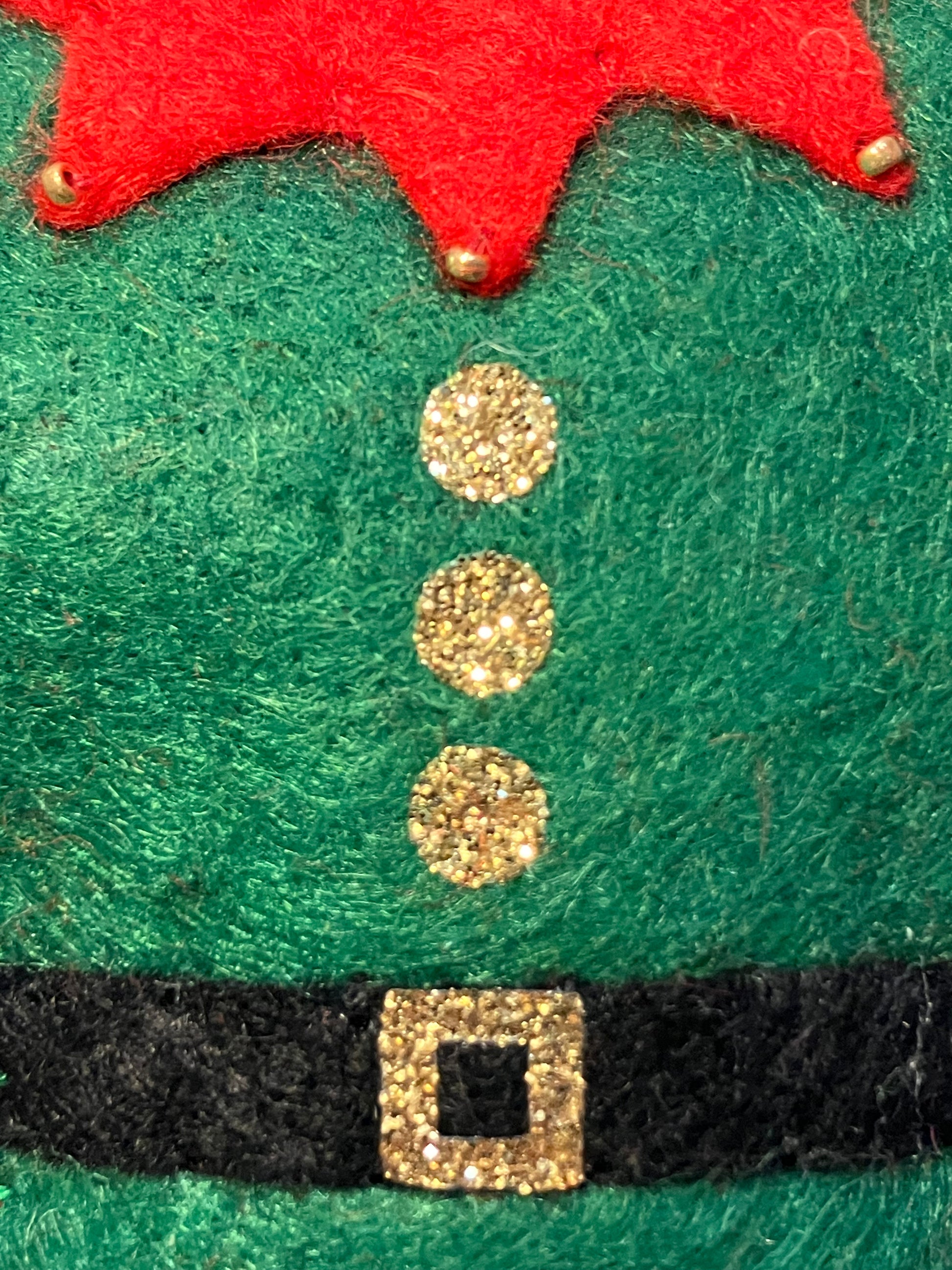 Close-up of the elf felt costume ornament's green body with gold buttons and belt.