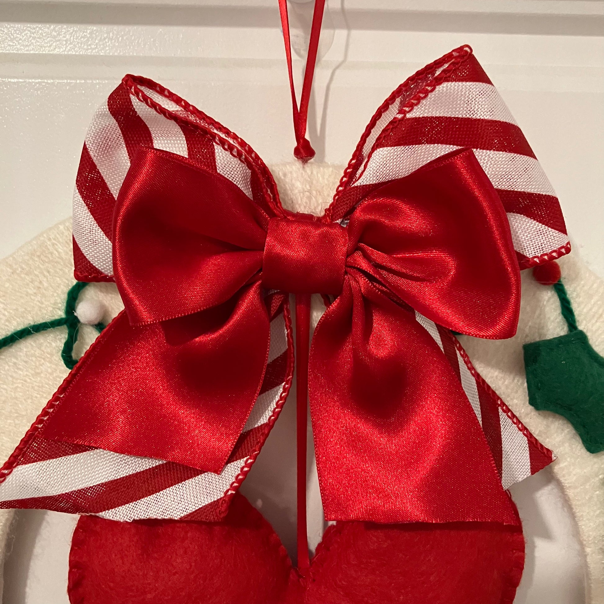 Red and white striped bow with a solid red bow on top.