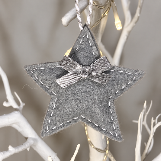 Grey felt star ornament with silver bow and white stitching — lighting-improved version of IMG_7328.