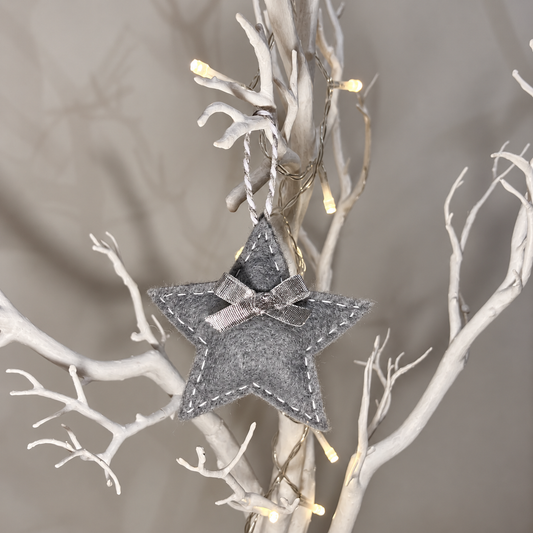 Grey felt star ornament with silver bow and white stitching — lighting-improved version of IMG_7329.
