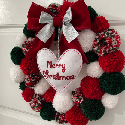 A festive red, green, and white pom-pom wreath with a "Merry Christmas" heart.