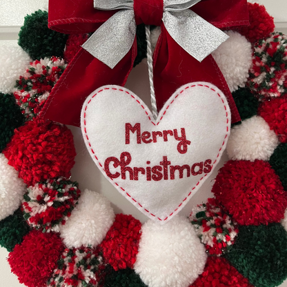 A festive red, green, and white pom-pom wreath with a "Merry Christmas" heart.