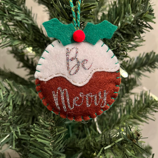 Handmade "Be Merry" Christmas pudding decoration on a Christmas tree.