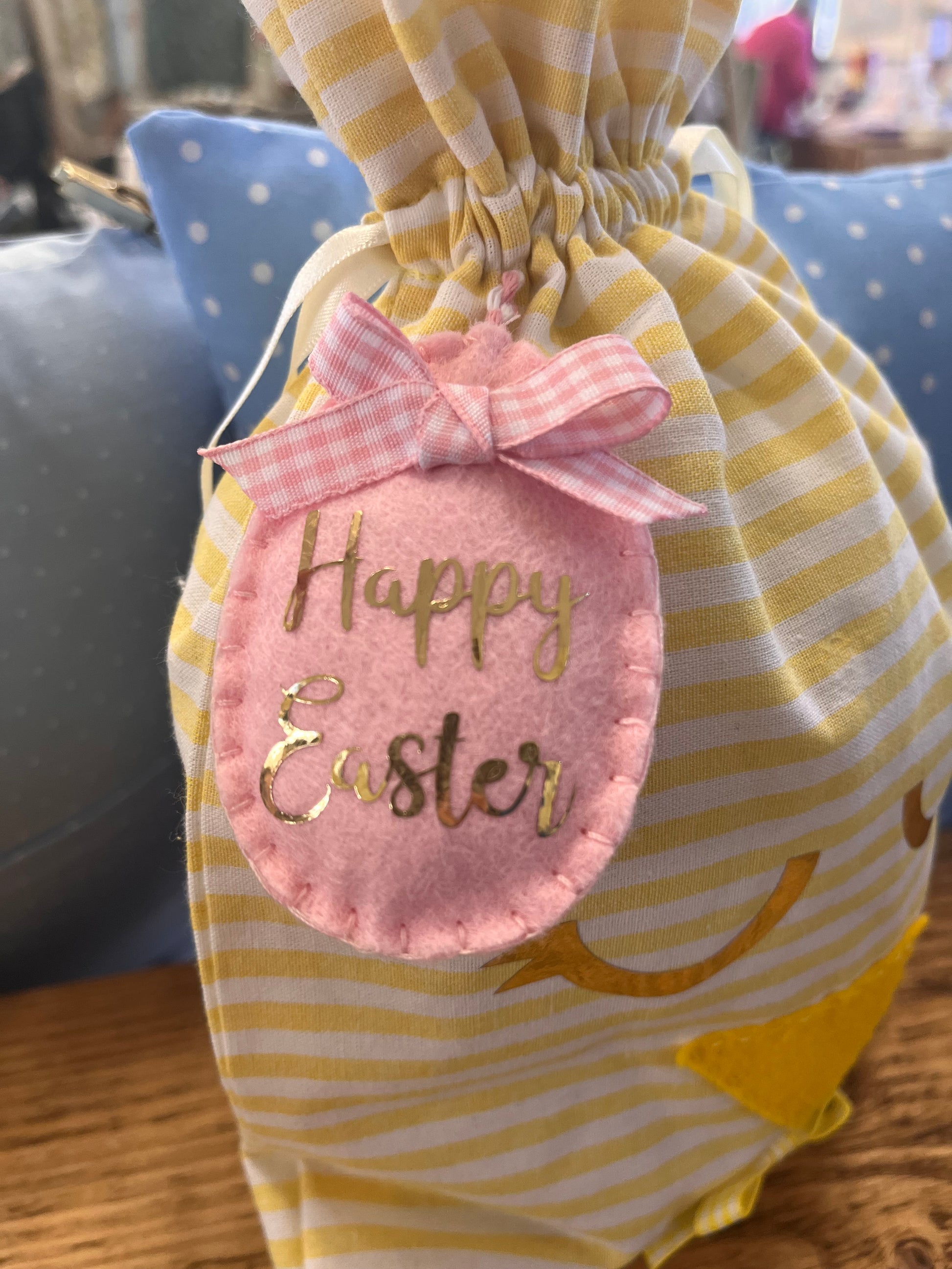 Yellow and white striped Easter bag with a pink felt egg tag that says Happy Easter.