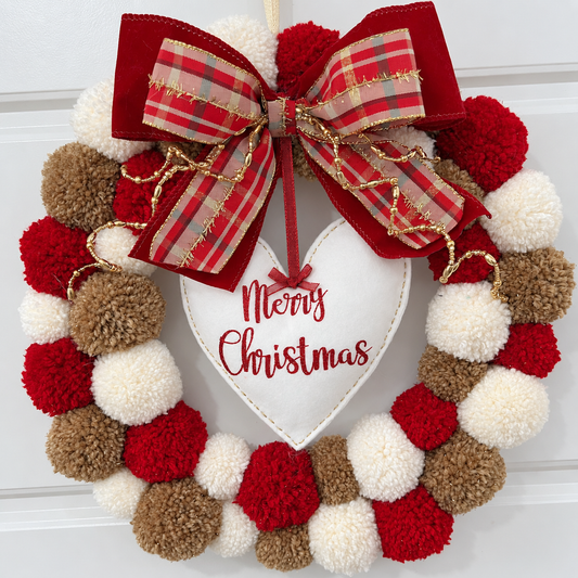 A festive red, white, and brown pom-pom wreath with a "Merry Christmas" heart.