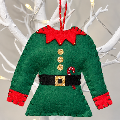 Felt elf tunic ornament in green with red collar and cuffs, gold buttons, and a black belt with a gold buckle.
