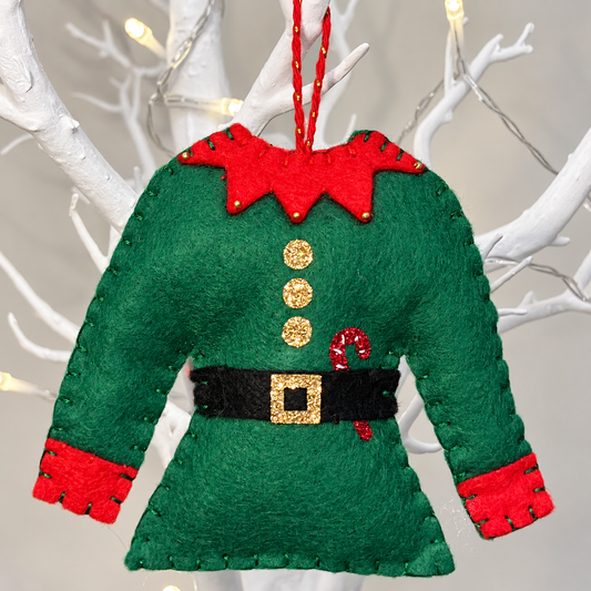 Felt elf tunic ornament in green with red collar and cuffs, gold buttons, and a black belt with a gold buckle.