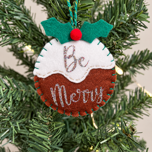 Felt Christmas pudding ornament with "Be Merry" in glitter, green holly leaves, and a red berry.